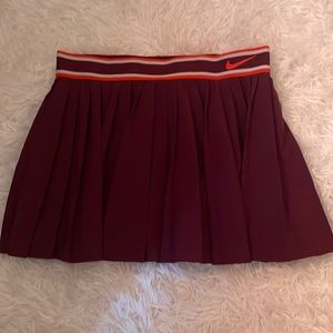 Nike tennis skirt. Size: women’s medium. Color: dark purple(maroon)/orange/white